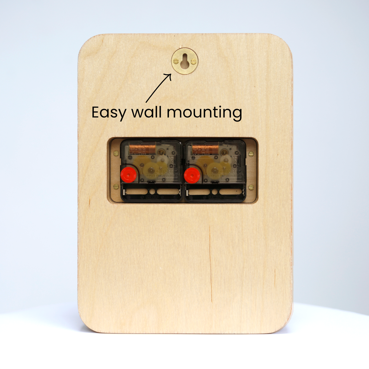A rectangular plywood piece containing two clock mechanisms. The image text 'easy wall mounting' points at a metal keyhole bracket.