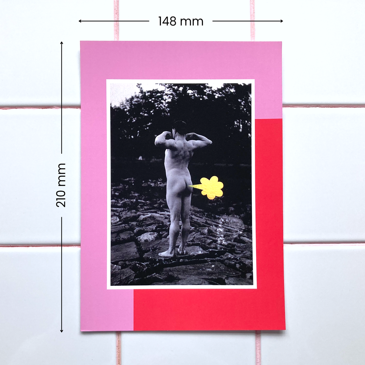 A 148x210mm poster featuring a photograph of a nude male flexing outdoors framed by a red and pink graphic border. A playful cartoon-style fart cloud, printed in holographic foil, is placed next to his bum.