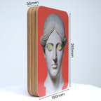A Unique art clock made of a rectangular plywood body with a printed statue head on a pink background mounted onto the front face. The image shows the measurements which are: height 265mm, width 190mm and thickness 36mm.