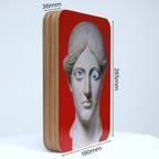 A unique art clock made of a rectangular plywood body with a printed statue head on a red background mounted onto the front face. The image shows the measurements which are: height 265mm, width 190mm and thickness 36mm.
