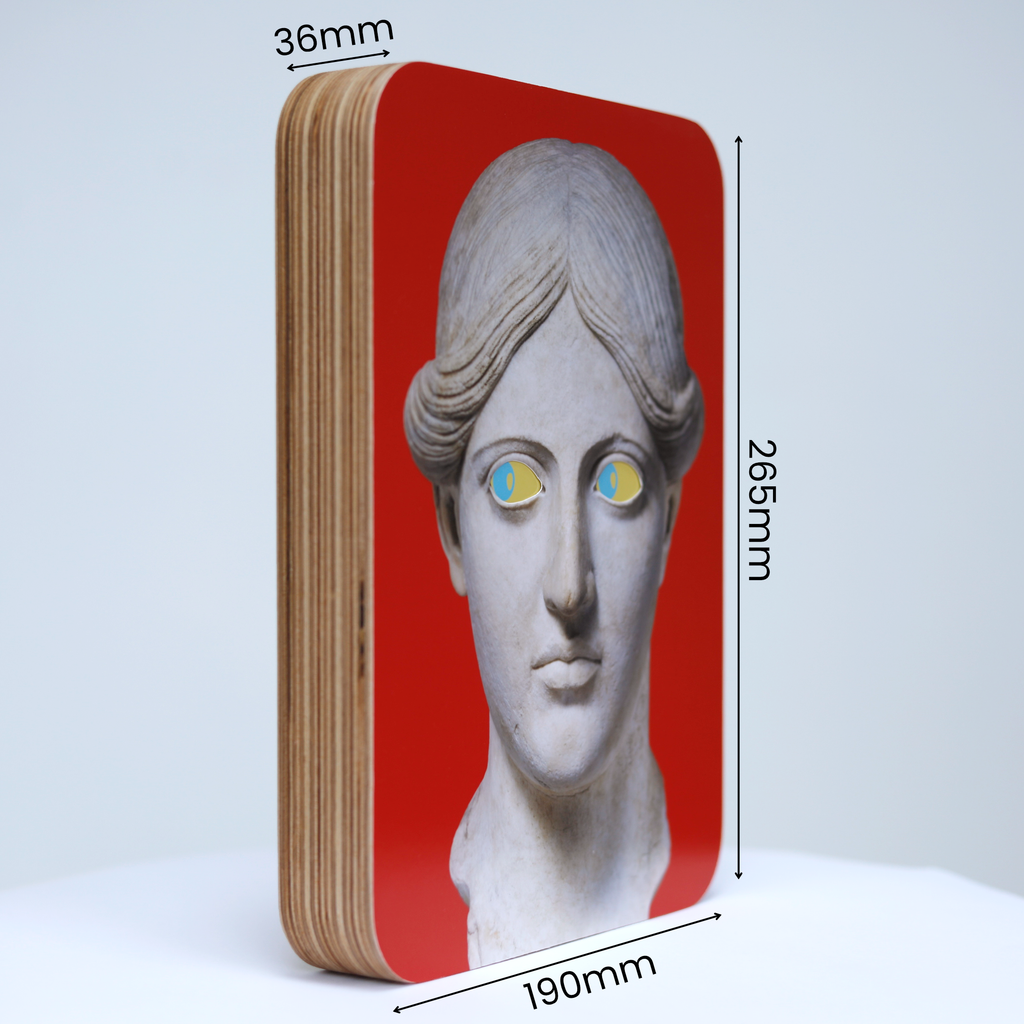 A unique art clock made of a rectangular plywood body with a printed statue head on a red background mounted onto the front face. The image shows the measurements which are: height 265mm, width 190mm and thickness 36mm.