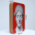 A unique art clock made of a rectangular plywood body with a printed statue head on a red background mounted onto the front face. The image shows the measurements which are: height 265mm, width 190mm and thickness 36mm.