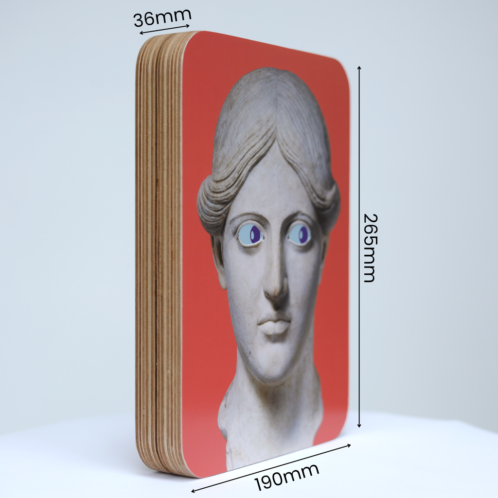 A unique art clock made of a rectangular plywood body with a printed statue head on a pink background mounted onto the front face. The image shows the measurements which are: height 265mm, width 190mm and thickness 36mm.